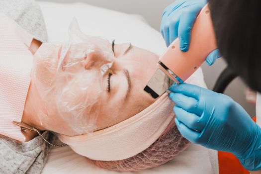 Cleansing the face from keratinized epithelium, excess fat, blockages of the sebaceous glands, comedones. Facial cleansing with an ultrasonic scrubber.