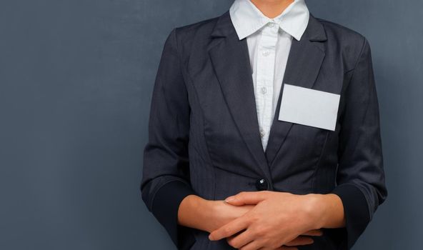 Businesswoman with a name tag on the chest, space for text