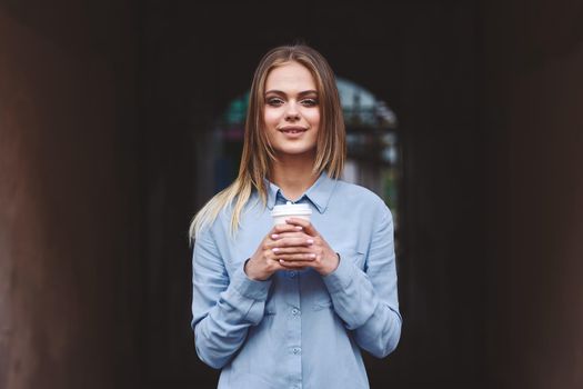 women outdoors drinking cup posing alleyway lifestyle. High quality photo