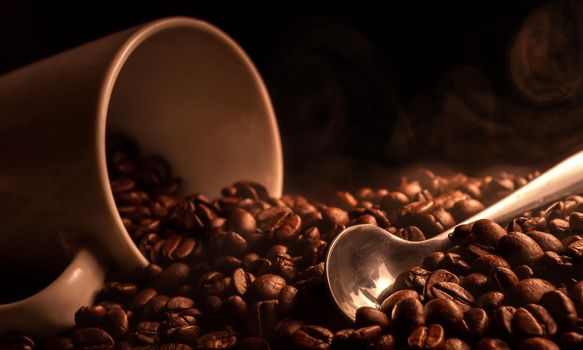 Spoon and a smoking mug of coffee beans