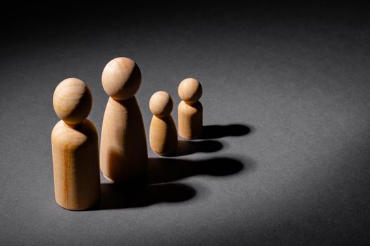 Wooden little figures of people close up. Family concept