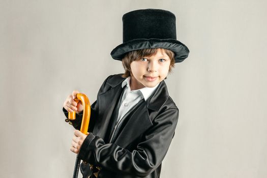 Young six year old boy wearing black suit. Cosplay, Retro party or Halloween costume rental concept