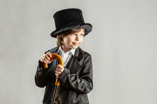 Young six year old boy wearing black suit. Cosplay, Retro party or Halloween costume rental concept