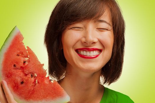 Happy young woman smiling with a piece of watermelon