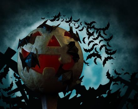 Carved Halloween pumpkin and bats on a background of the moon