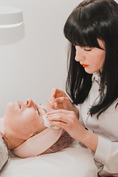 Facial massage at the beautician at the reception, visiting a beauty salon, a sense of relaxation. new