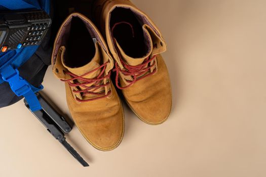 Blue backpack and hiking boots. Mountain gear ready for trip close up