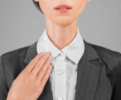 Young businesswoman straightens collar