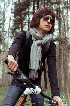 Portrait of woman on bicycle in the woods