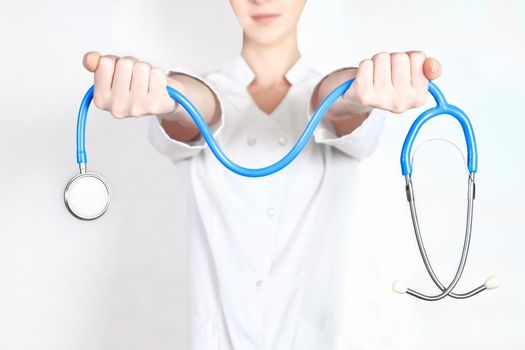 doctor gives the woman in the hands of a stethoscope