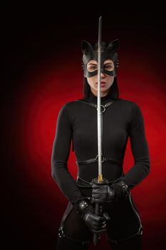 the woman in a black belt and cat mask with a katana