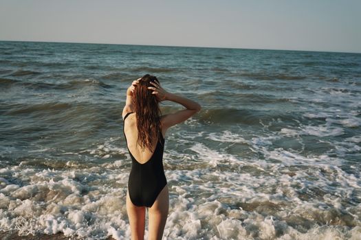 woman in black swimsuit sunglasses sun nature. High quality photo