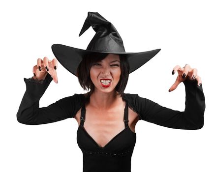Halloween witch standing with arms raised on a white background