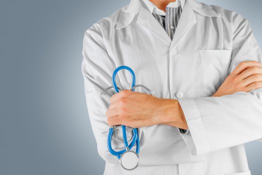 Confident male doctor with arms crossed. The face is not visible
