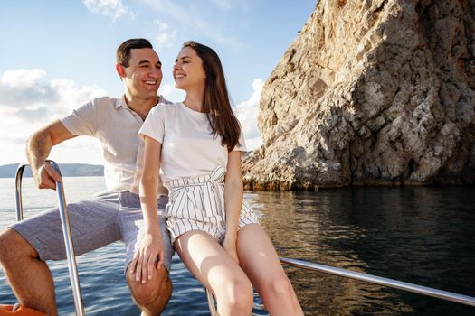 Happy couple in love on a yacht in summer on romantic vacation