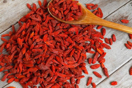 Heap of goji berries on a wooden background
