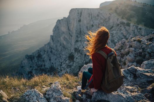 woman hiker sitting on mountain landscape nature fresh air. High quality photo