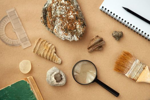 Stone samples, loop, notebook at geological laboratory. Geology rock laboratory. Laboratory for analysis of geological soil materials, stones, minerals, rocks samples for researchers- Brushing samples.