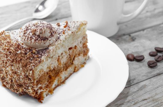 Piece of cake and a cup of coffee on a wooden table