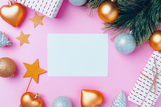 Christmas festive decorations with copy space on pink background, top view