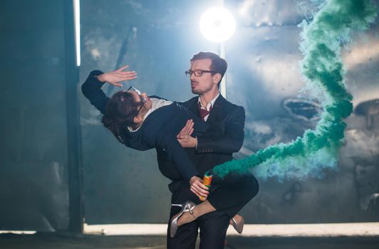 Pasadoble, latin solo dance and contemporary dance - Handsome man and woman dancing into smoke cloud