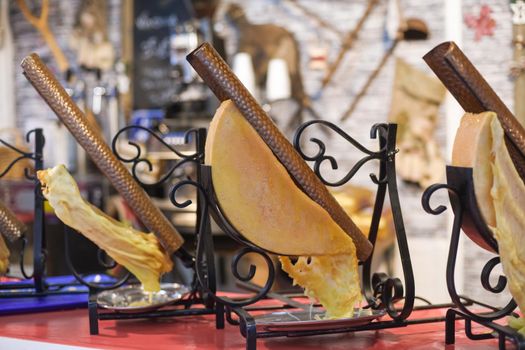 Melted cheese raclette at a french fair market