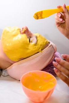 Golden mask on a woman's face, aromatic mask for relaxation and skin hydration, visits to the spa. new