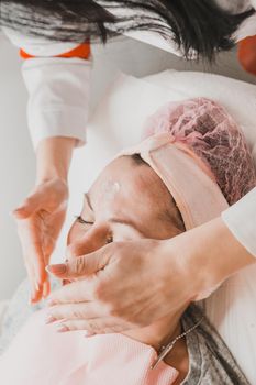 Facial massage at the beautician at the reception, visiting a beauty salon, a sense of relaxation. new