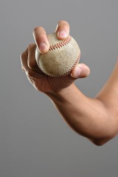 closeup baseball in man's hand, isolated over background