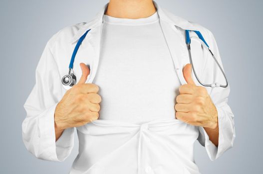 Man doctor pulling open white coat on the chest on a gray background