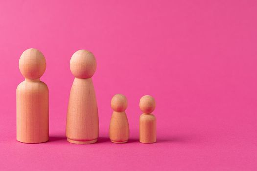 Wooden little figures of people close up. Family concept