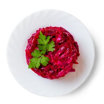 Beet salad on a white plate, top view.