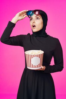 Muslim woman attractive look popcorn glasses movie watching isolated background. High quality photo