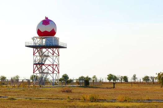 Aeronautical meteorological station tower with spherical radar at airport area