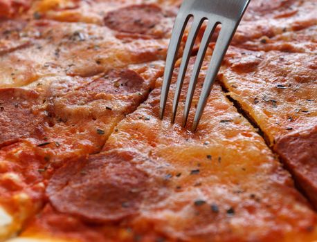 Close-up of a piece of pizza and fork