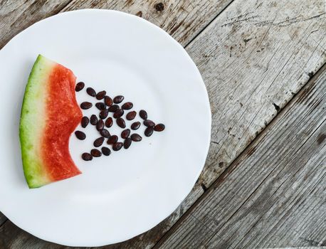 Eaten watermelon on a plate with pits