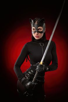 the woman in a black belt and cat mask with a katana