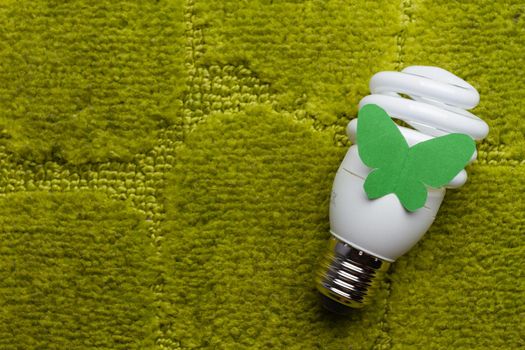 Energy saving bulb on a green background