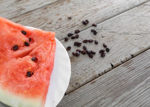 Slice of watermelon on a wooden table