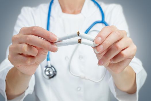 Unrecognizable doctor breaking a cigarette