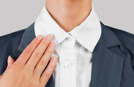 Unrecognizable female office worker holds white collar, close-up