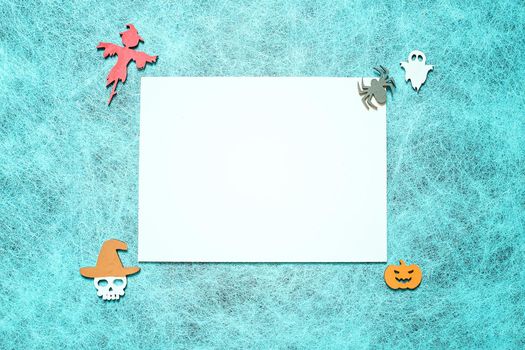 Holiday helloween on a spider web background with a white leaf, pumpkin, ghost, scarecrow, skull, witch