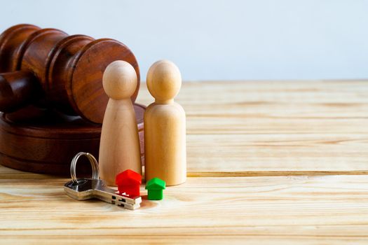 Divorse property division concept. Wooden family with house and judge gavel close up