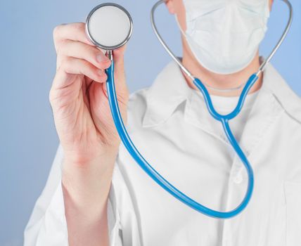 Male doctor listens to a stethoscope, close-up
