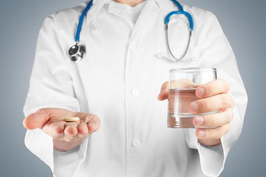 Unrecognizable male doctor gives a pill