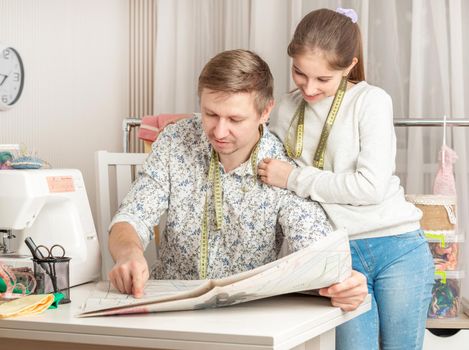 cute little girl and her dad in a sewing workshop