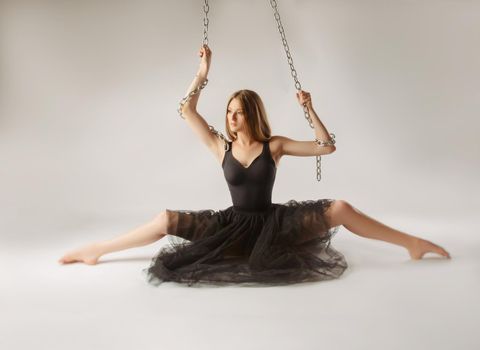 girl dancing with a large chain in an incredible ballerina pose