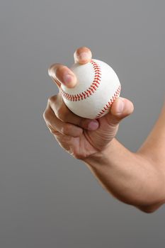 closeup baseball in man's hand, isolated over background