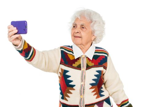 elderly woman taking selfie on a smartphone isolated on white background