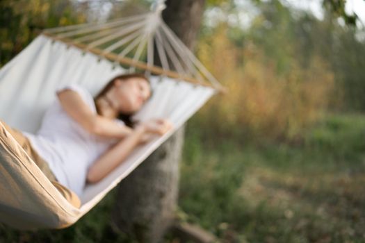 woman sleeping in hammock outdoors leisure lifestyle. High quality photo